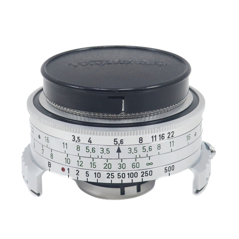 NISHIKINO VINTAGE KYOTOのフォクトレンダー SKOPARON 35mm F3.5 交換レンズ、シルバーの鏡筒と黒いキャップ付き